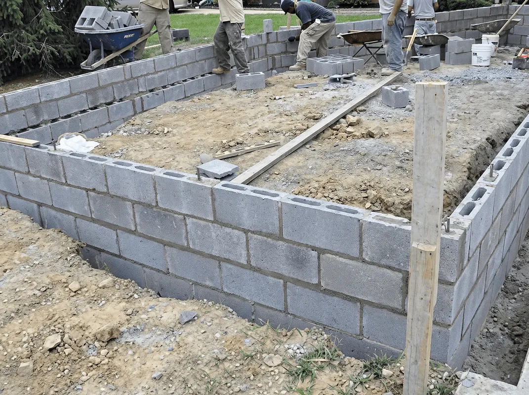 Professionals building a foundation with blocks in Huntsville, AL