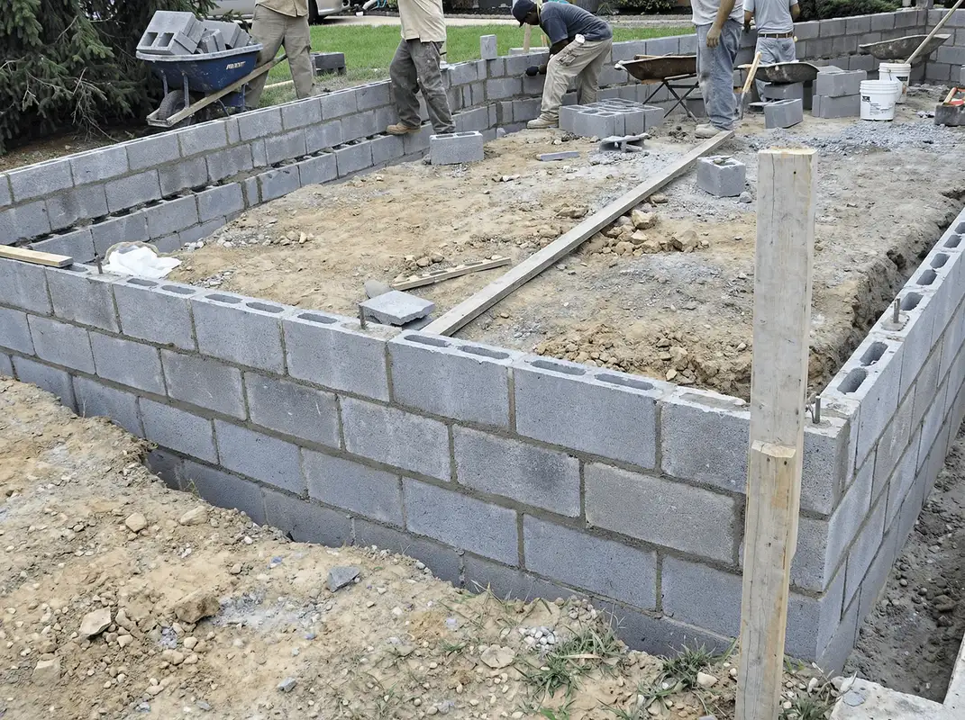 Professionals building a foundation with blocks in Huntsville, AL