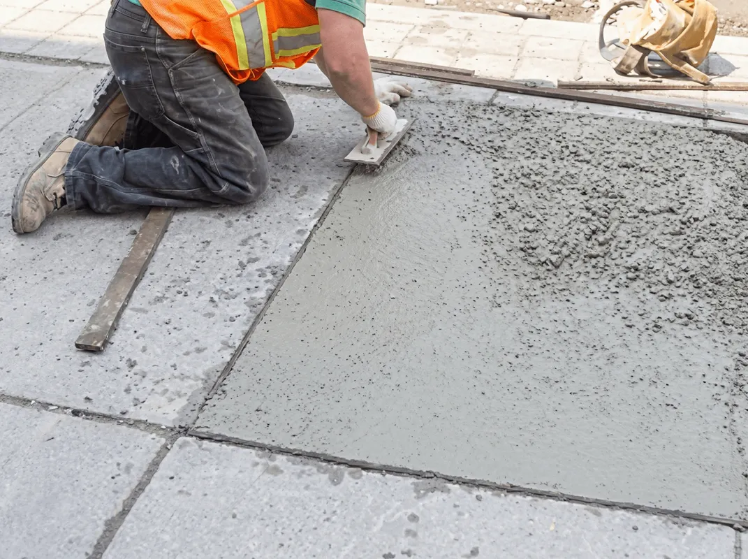 Professional repairing a concrete floor in Huntsville, AL